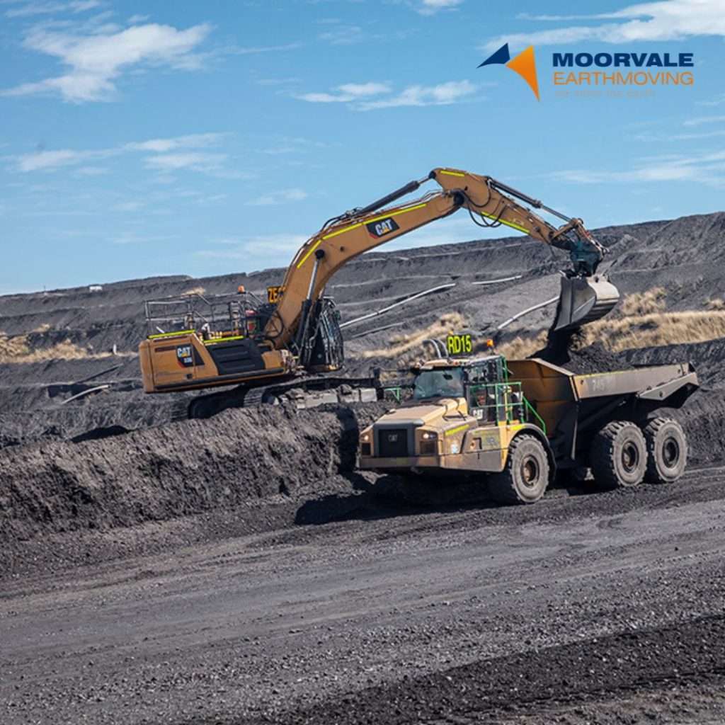 Digger and dump truck on mine site